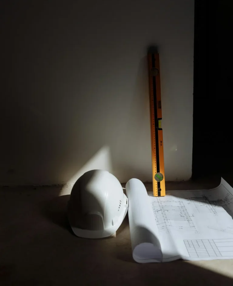 A hard hat, level, and blueprints in a construction setting, highlighting precision.